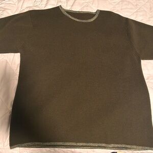 Green knit top with patterned hem